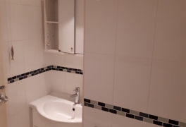 basin in alcove next to cupboard