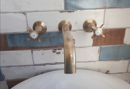 Brass wall-mounted basin taps