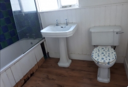 Old wood panelling on walls and bath had decayed