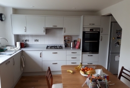 completed kitchen with grey Silestone worktops/upstands and tiled splashback